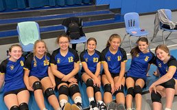 OLPH volleyball team smiling as a group