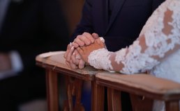 couple at wedding holding hands