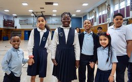students of various ages from St Clare Catholic Academy in gym