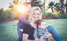 Mom plays outside with two young kids