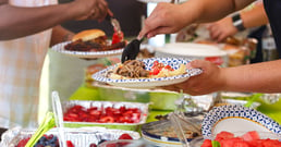 people get food at a potluck