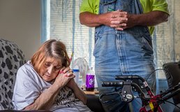 homebound person praying with visitor