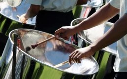 hands playing steel drums