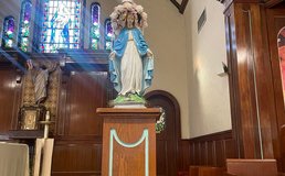 statue of mary with flowers