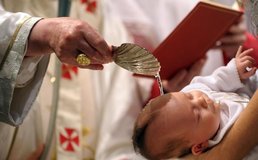 baby being baptized by priest