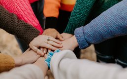 hands together in the middle of a circle