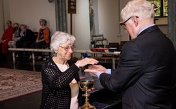lay minister distributing Communion