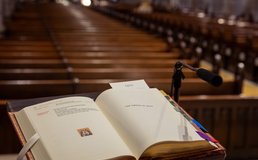 book on podium with empty pews in background