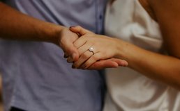 holding hands with engagement ring