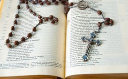 rosary on Bible