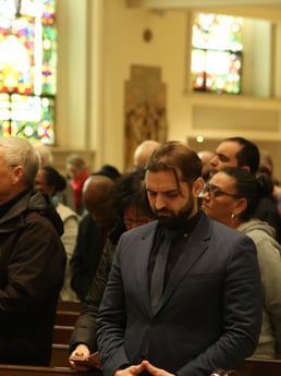 people in pews attending Mass