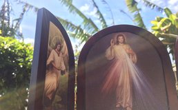 An image of the Divine Mercy shines in the sun