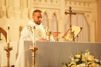 Father Torres on altar during Mass