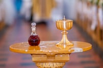 communion wine and host in chalice