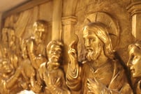 a sculpture shows Jesus holding the first Eucharist