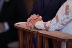 couple at wedding holding hands
