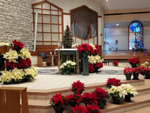 Our Lady of Perpetual Help sanctuary decorated with red and white poinsettias for Christmas