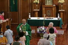 Fr. Diaz and Extraordinary Minister of the Eucharist during Communion