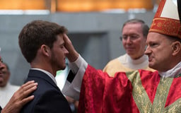 priest blessing RCIA candidate