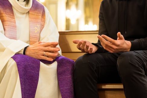 A priest and parishioner having a conversation 